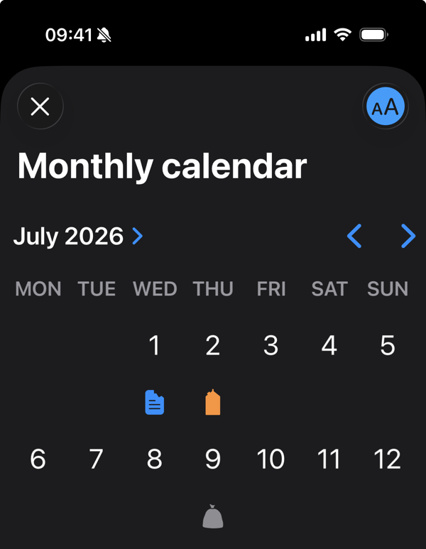 Toggling the text size makes the calendar view icons more legible. A text size toggle in the screen toolbar is switched on and the monthly calendar with icons on certain dates increases its text size.